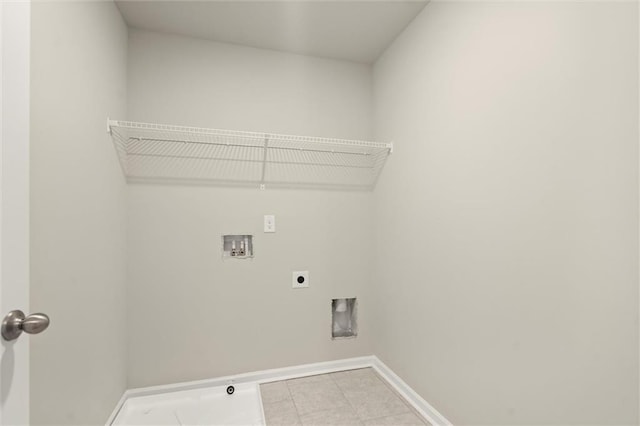 laundry area featuring light tile patterned floors, hookup for a washing machine, laundry area, baseboards, and electric dryer hookup