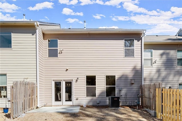 rear view of house with a patio area, fence, and cooling unit