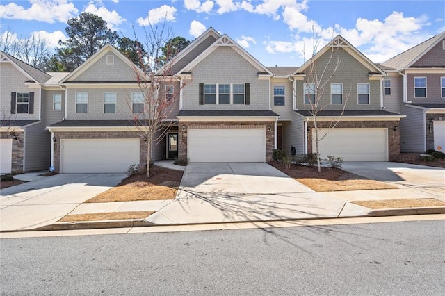 view of property featuring concrete driveway and an attached garage