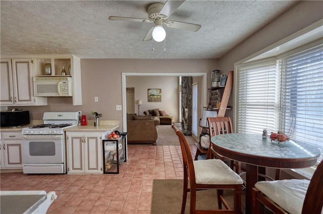 744 Hampton Locust Grove Rd, Hampton, GA 30228 - dining space with ceiling fan, light tile patterned flooring, and a textured ceiling