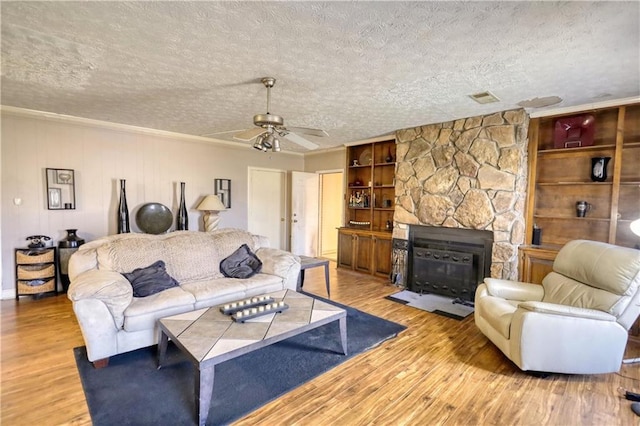 744 Hampton Locust Grove Rd, Hampton, GA 30228 - living room with a fireplace, light hardwood / wood-style flooring, and a textured ceiling