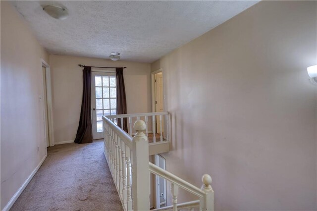 744 Hampton Locust Grove Rd, Hampton, GA 30228 - corridor featuring light carpet and a textured ceiling