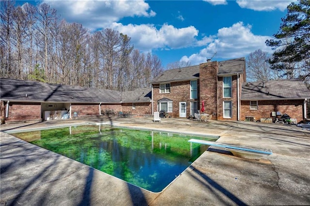 744 Hampton Locust Grove Rd, Hampton, GA 30228 - view of swimming pool featuring a patio and a diving board