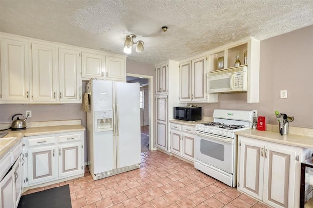 744 Hampton Locust Grove Rd, Hampton, GA 30228 - kitchen featuring white appliances, light tile patterned flooring, white cabinets, and a textured ceiling