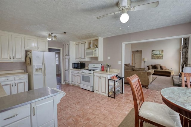 744 Hampton Locust Grove Rd, Hampton, GA 30228 - kitchen with white appliances, white cabinetry, ceiling fan, and a textured ceiling