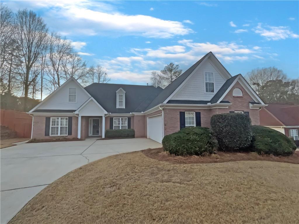 290 Virginia Highlands, Fayetteville, GA 30215 - view of front of home featuring a garage, brick siding, and concrete driveway