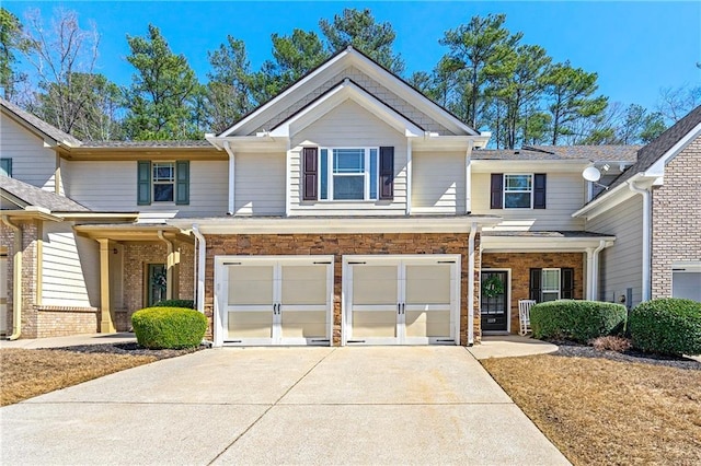 view of front of property with stone siding, an attached garage, and concrete driveway