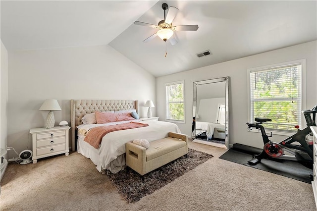 carpeted bedroom with visible vents, a ceiling fan, and vaulted ceiling