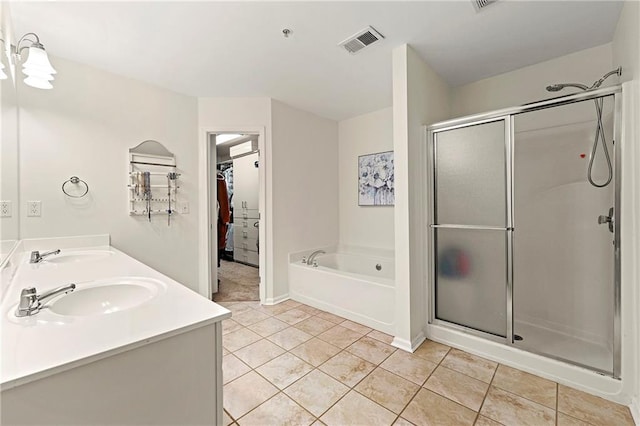 full bath featuring visible vents, a sink, tile patterned flooring, a shower stall, and a bath