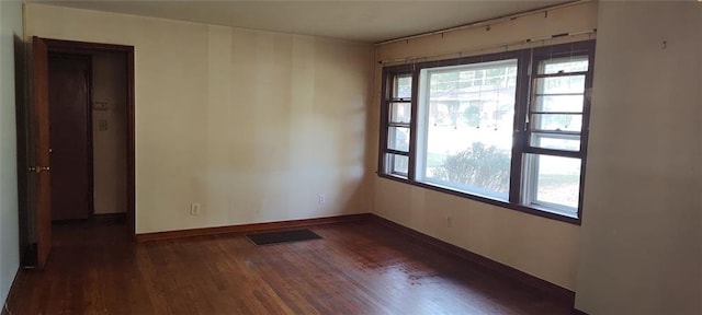 spare room featuring dark hardwood / wood-style flooring