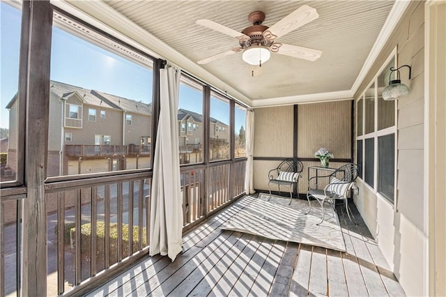 sunroom featuring ceiling fan