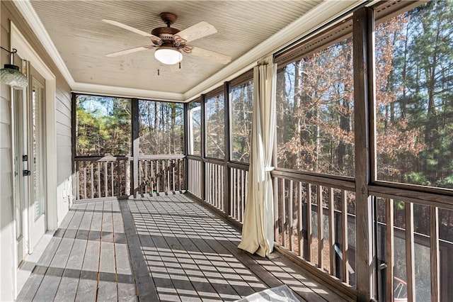 unfurnished sunroom with ceiling fan and wood ceiling