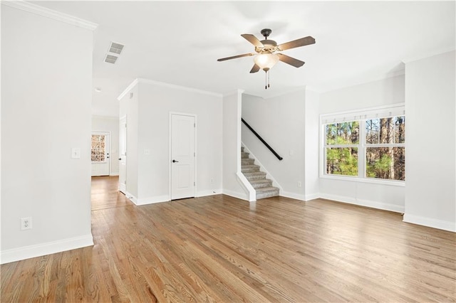 spare room with light hardwood / wood-style floors, crown molding, and ceiling fan