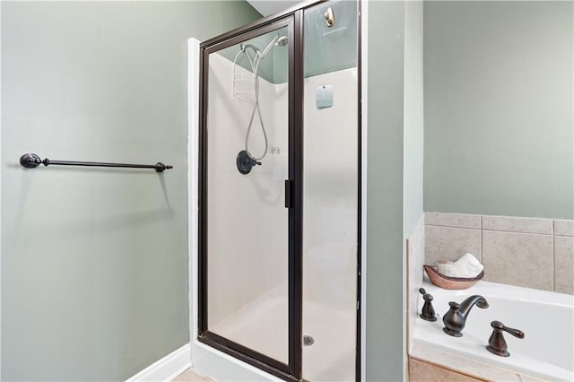 bathroom with shower with separate bathtub