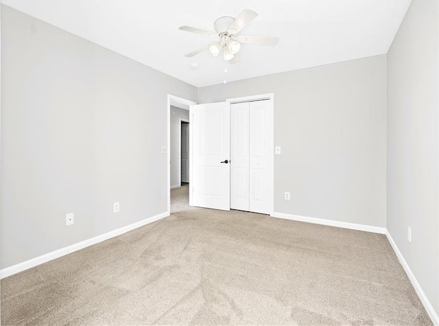 unfurnished room with ceiling fan and light colored carpet