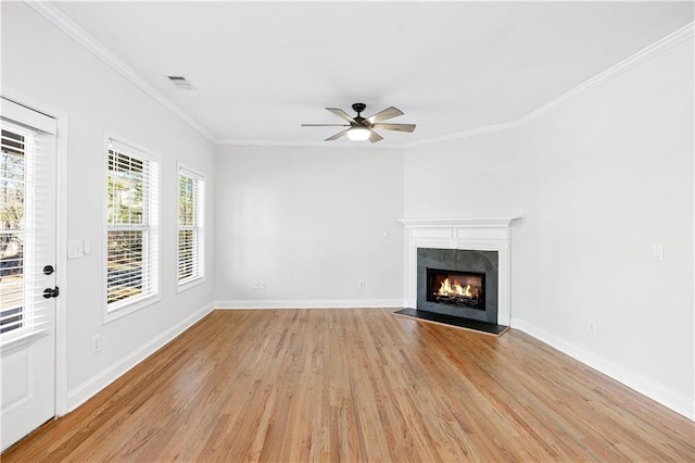 unfurnished living room featuring ceiling fan, ornamental molding, and light hardwood / wood-style floors