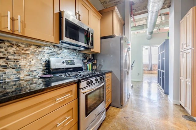 kitchen with stainless steel appliances, concrete floors, baseboards, backsplash, and dark stone counters