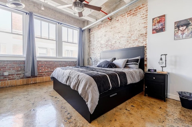 bedroom with concrete flooring, baseboards, ceiling fan, and brick wall