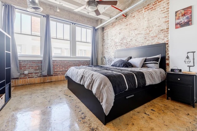 bedroom featuring brick wall, ceiling fan, and concrete flooring