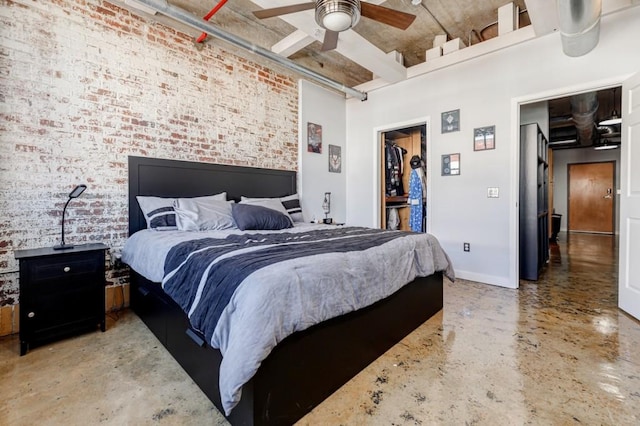 bedroom with baseboards, concrete floors, a towering ceiling, and brick wall