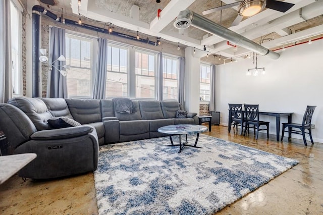 living area with baseboards, concrete floors, visible vents, and a ceiling fan