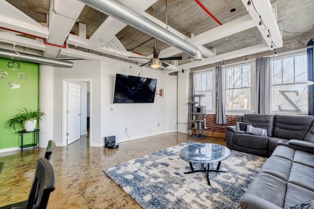 living room with a ceiling fan, concrete floors, and baseboards