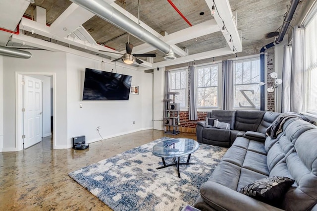 living area with ceiling fan, concrete floors, and baseboards