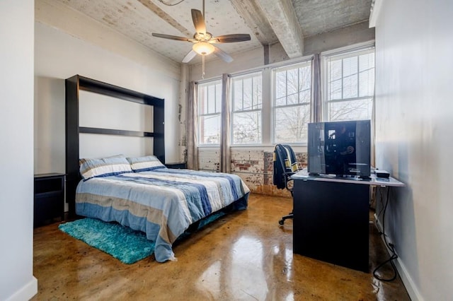 bedroom featuring a ceiling fan, baseboards, and concrete flooring