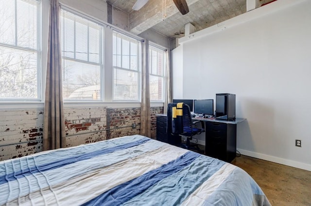 bedroom with a ceiling fan, concrete floors, and baseboards