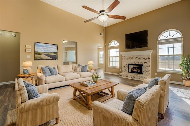 living room featuring ceiling fan and light hardwood / wood-style floors