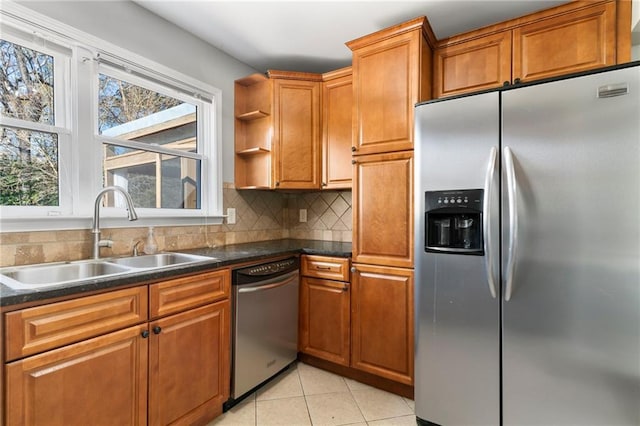 kitchen featuring decorative backsplash, sink, light tile patterned flooring, and stainless steel appliances