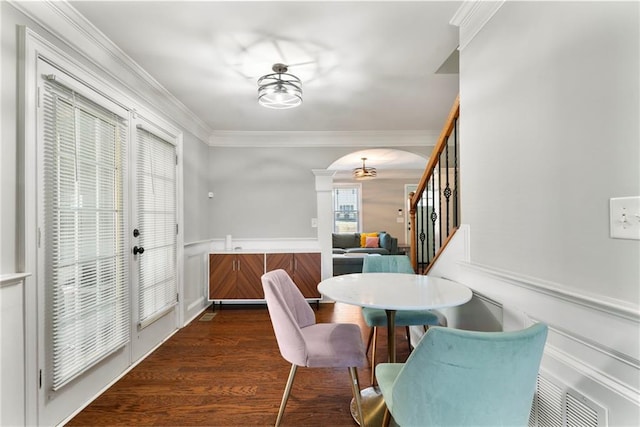 dining room featuring crown molding and dark hardwood / wood-style floors