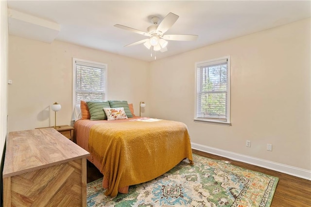 bedroom featuring multiple windows, ceiling fan, and dark wood-type flooring