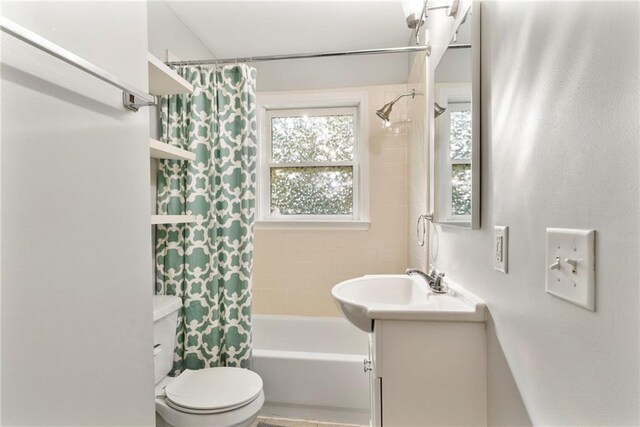 full bathroom featuring shower / bath combo with shower curtain, vanity, and toilet