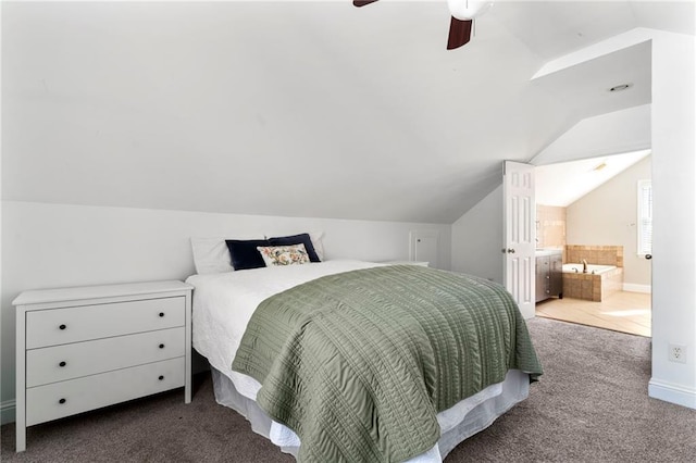 bedroom with carpet, ensuite bathroom, ceiling fan, and lofted ceiling