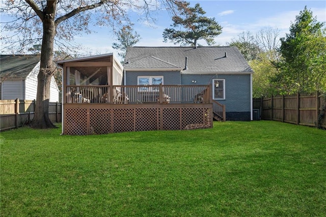 back of house featuring a lawn, a sunroom, and a deck