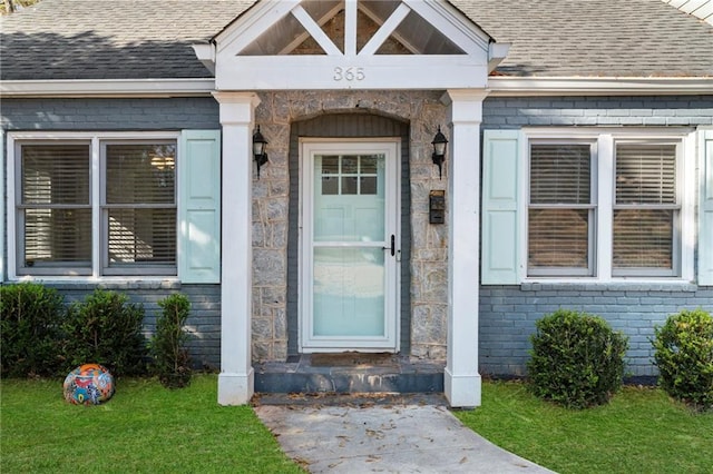 doorway to property with a lawn