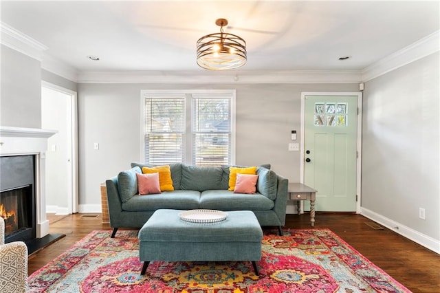 living room with dark hardwood / wood-style flooring and ornamental molding