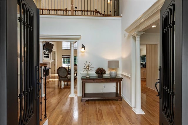 135 Stone Orchard Ct, Milton, GA 30004 - foyer featuring decorative columns, a towering ceiling, and light wood-style flooring