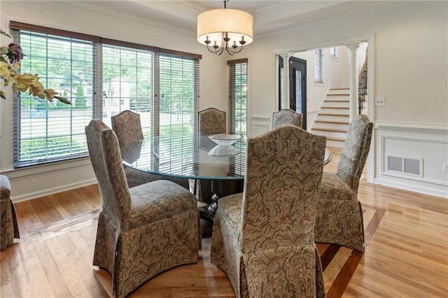135 Stone Orchard Ct, Milton, GA 30004 - dining area with crown molding, a chandelier, healthy amount of natural light, wood finished floors, and a wainscoted wall