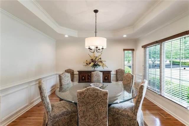 135 Stone Orchard Ct, Milton, GA 30004 - dining room with a chandelier, a tray ceiling, wood finished floors, a wainscoted wall, and crown molding