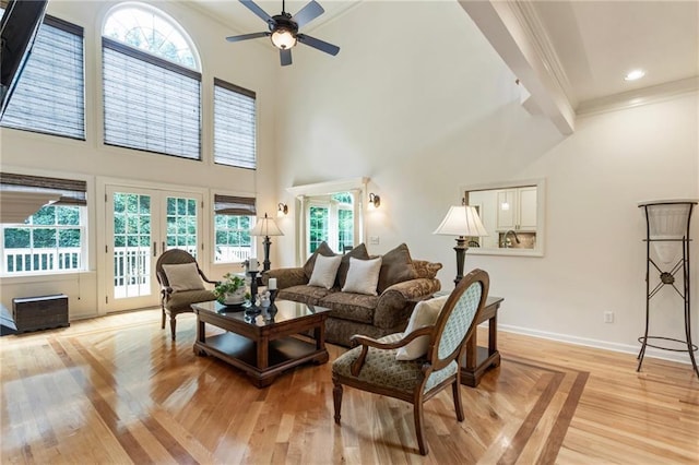 135 Stone Orchard Ct, Milton, GA 30004 - living room featuring a towering ceiling, crown molding, a ceiling fan, baseboards, and healthy amount of natural light