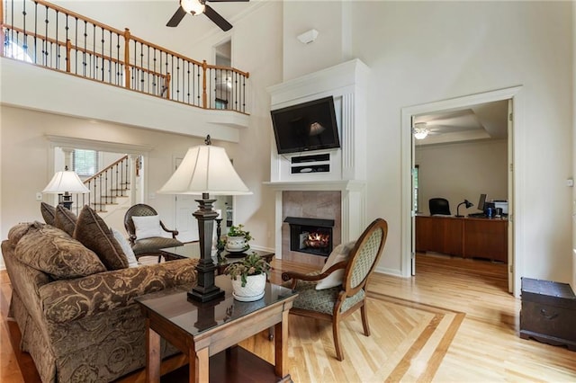 135 Stone Orchard Ct, Milton, GA 30004 - living room with ceiling fan, wood finished floors, an office area, a tile fireplace, and a high ceiling