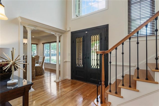 135 Stone Orchard Ct, Milton, GA 30004 - entryway with wood finished floors, stairway, decorative columns, and a towering ceiling