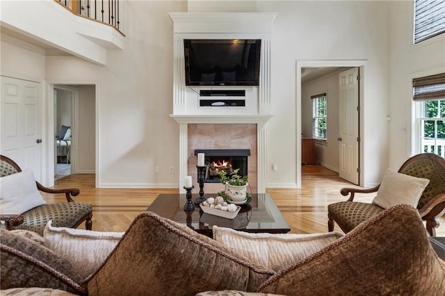 135 Stone Orchard Ct, Milton, GA 30004 - living area with a towering ceiling, a fireplace, wood finished floors, and baseboards