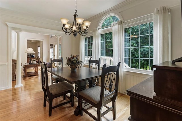 135 Stone Orchard Ct, Milton, GA 30004 - dining space with decorative columns, light wood-style flooring, ornamental molding, a chandelier, and a wainscoted wall