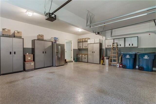 135 Stone Orchard Ct, Milton, GA 30004 - garage featuring stainless steel fridge and a garage door opener