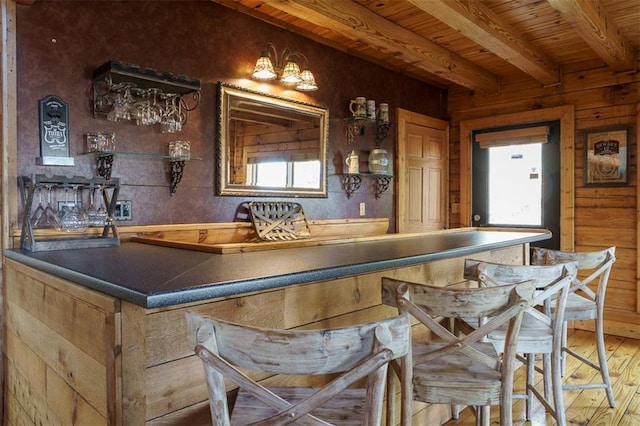 bar featuring hardwood / wood-style floors, wood ceiling, and beamed ceiling