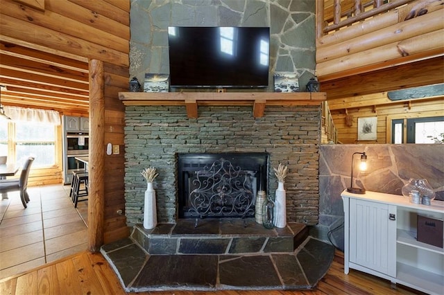 living room featuring hardwood / wood-style flooring and a stone fireplace