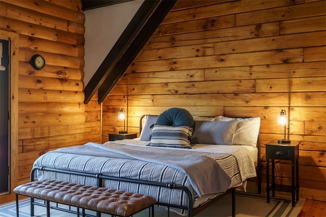 bedroom with hardwood / wood-style floors and wooden walls